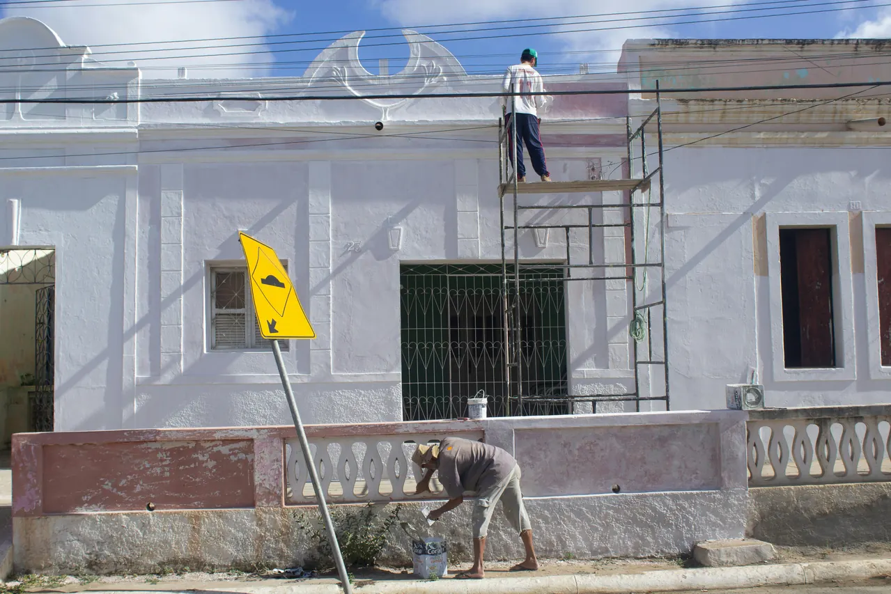 Workers on scaffolding carrying out facade work